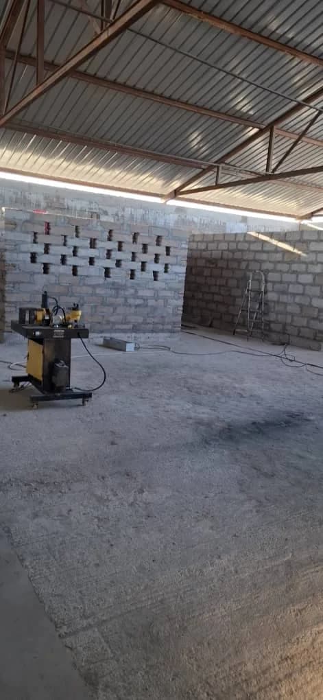 Block wall under construction inside the plant building