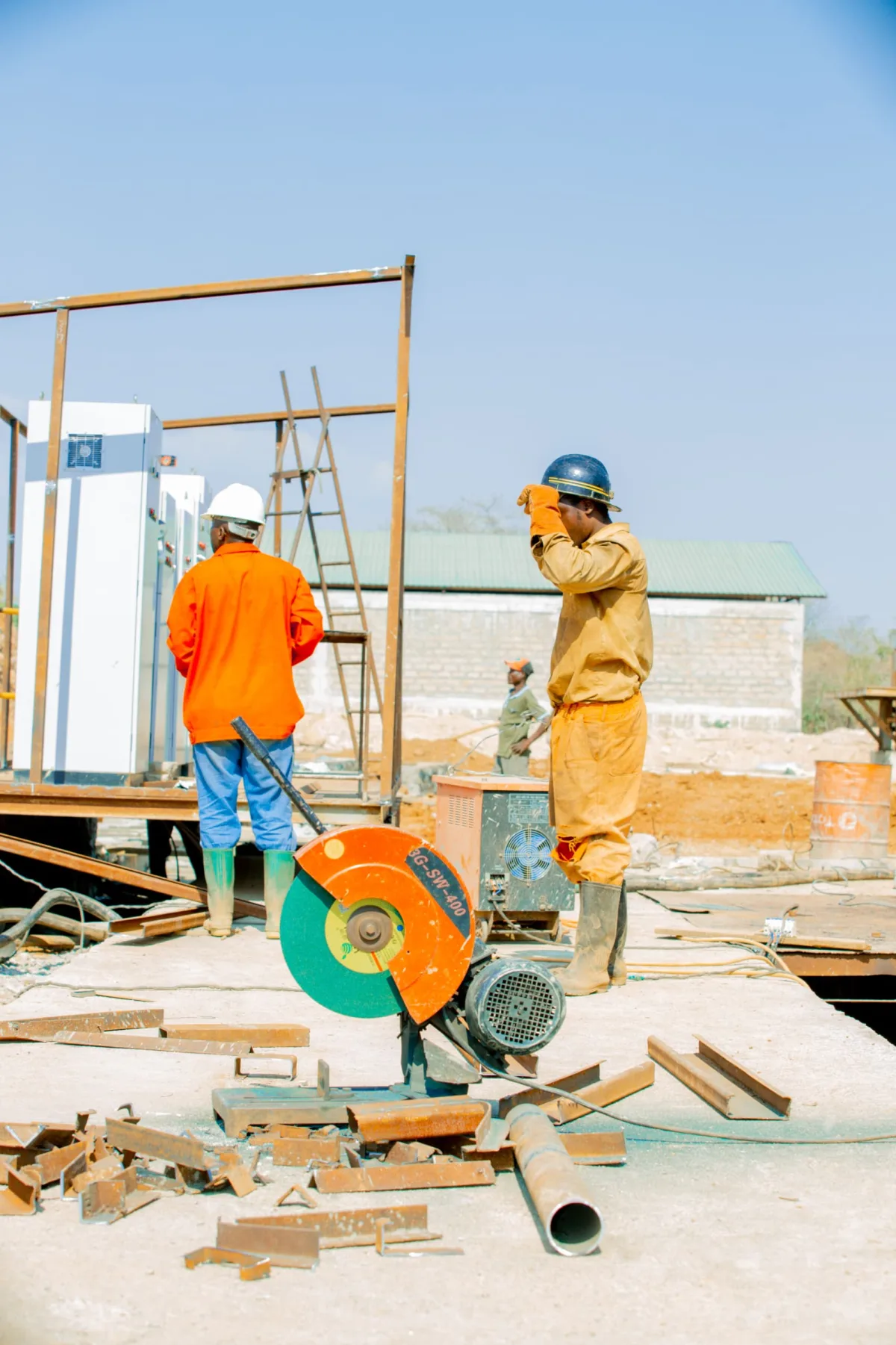 Workers preparing a cut-off saw on site