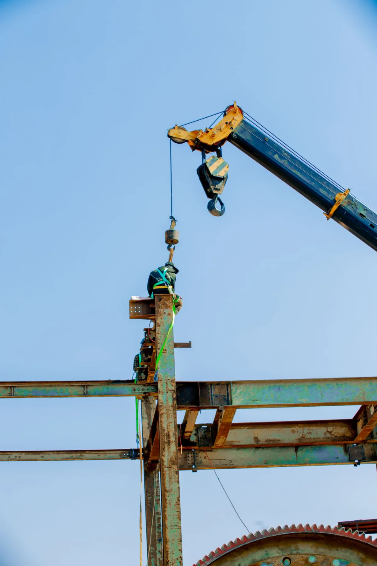 Worker guided by crane to the steelwork above