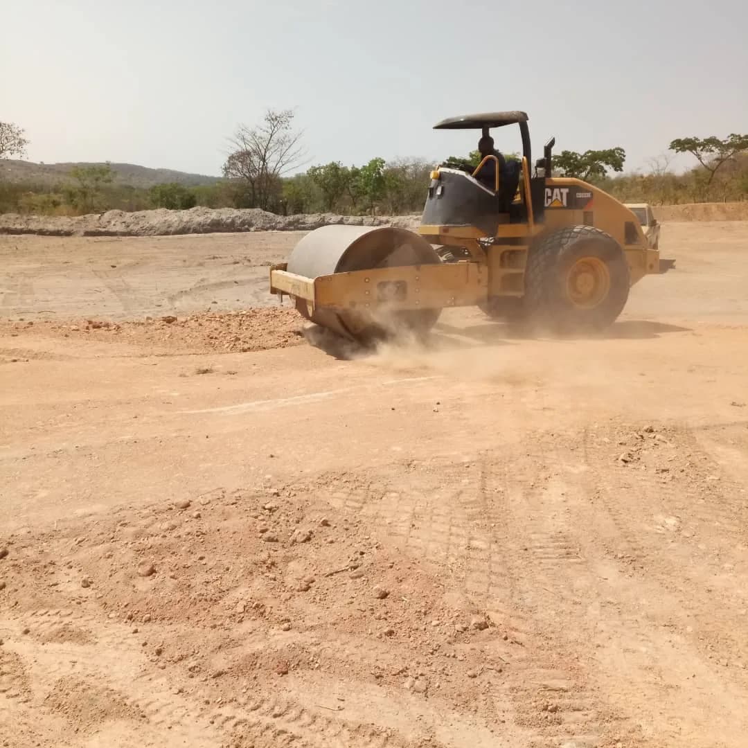 Grader and roller compacting the TSF pad together