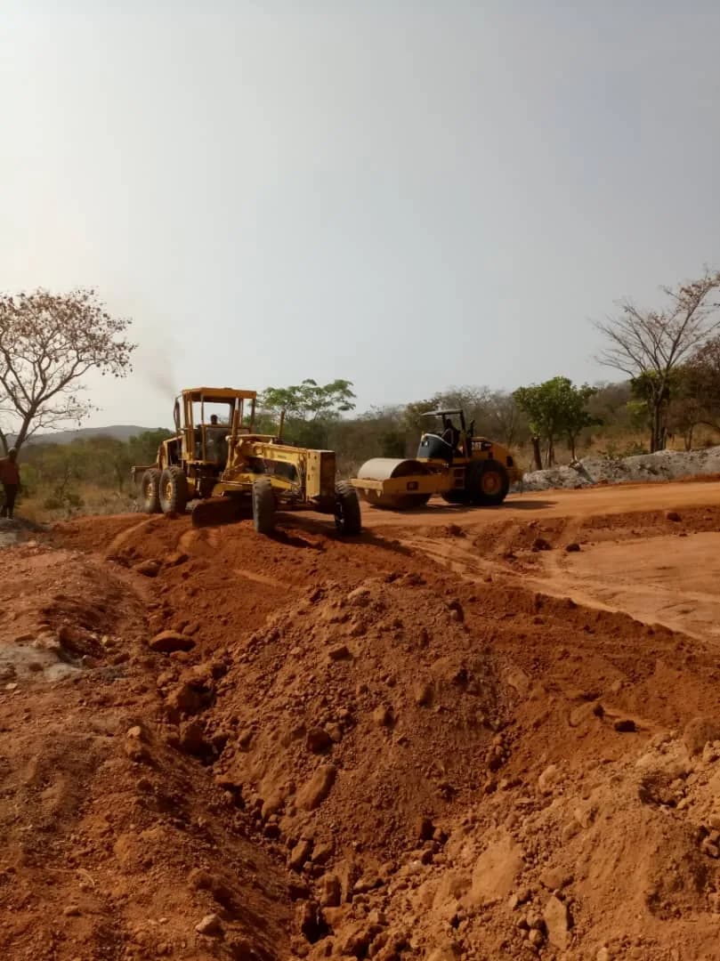 Grader and roller working the embankment surface