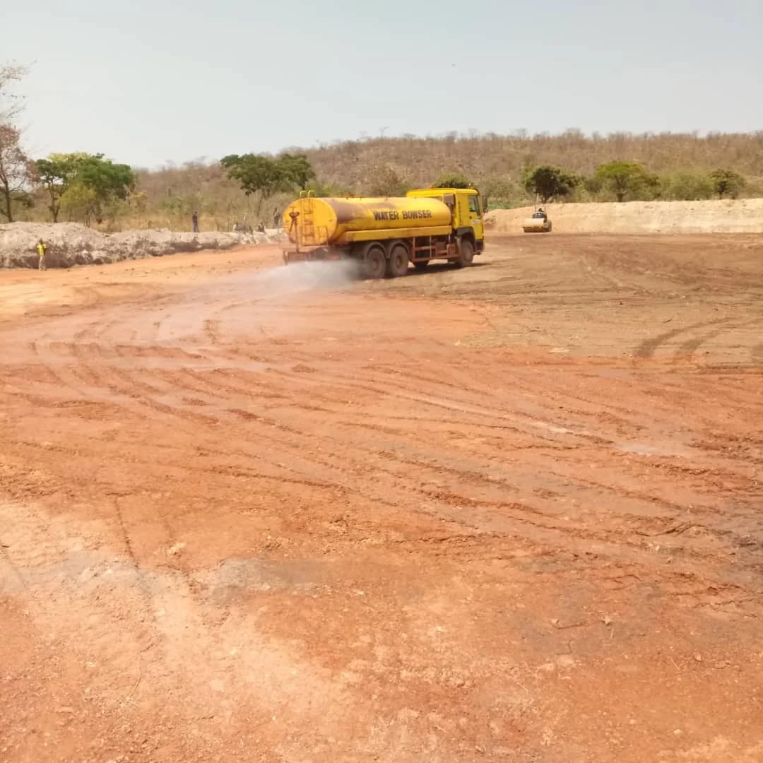 Water bowser truck spraying the access road