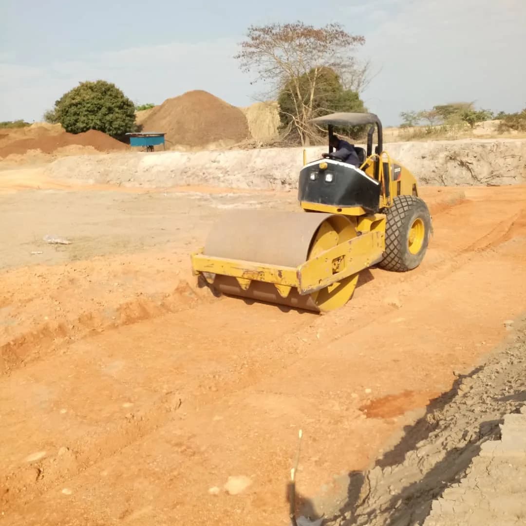 Roller compacting the clay-lined edge of the TSF