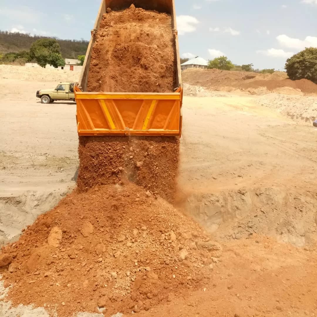Dump truck tipping fill material onto the TSF pad