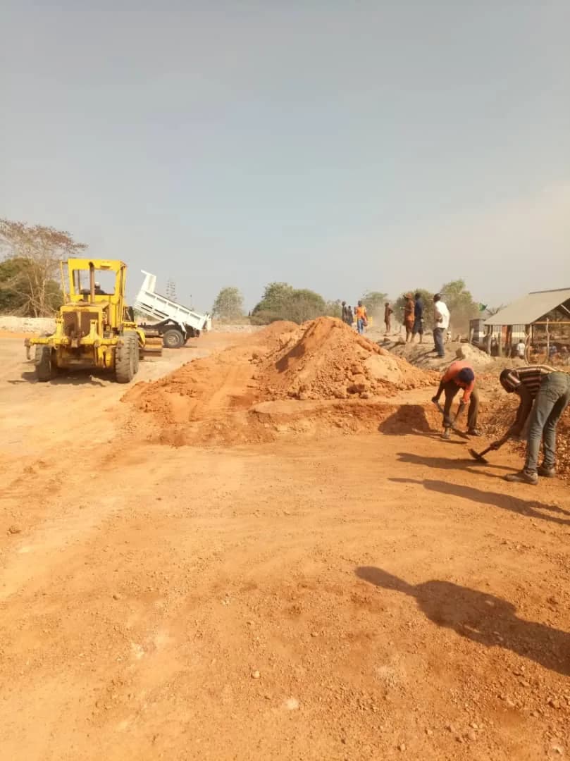 Grader and dump truck working the TSF pad together