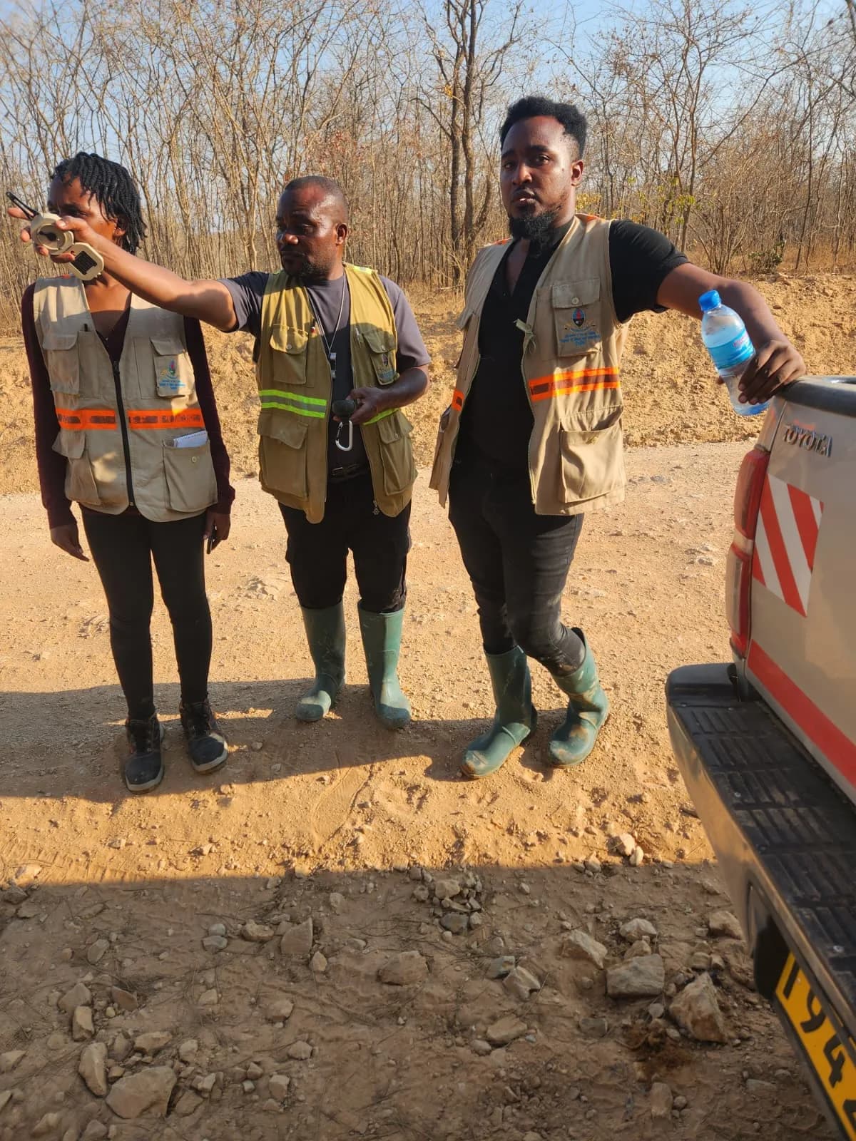 Exploration team pausing by the field vehicle
