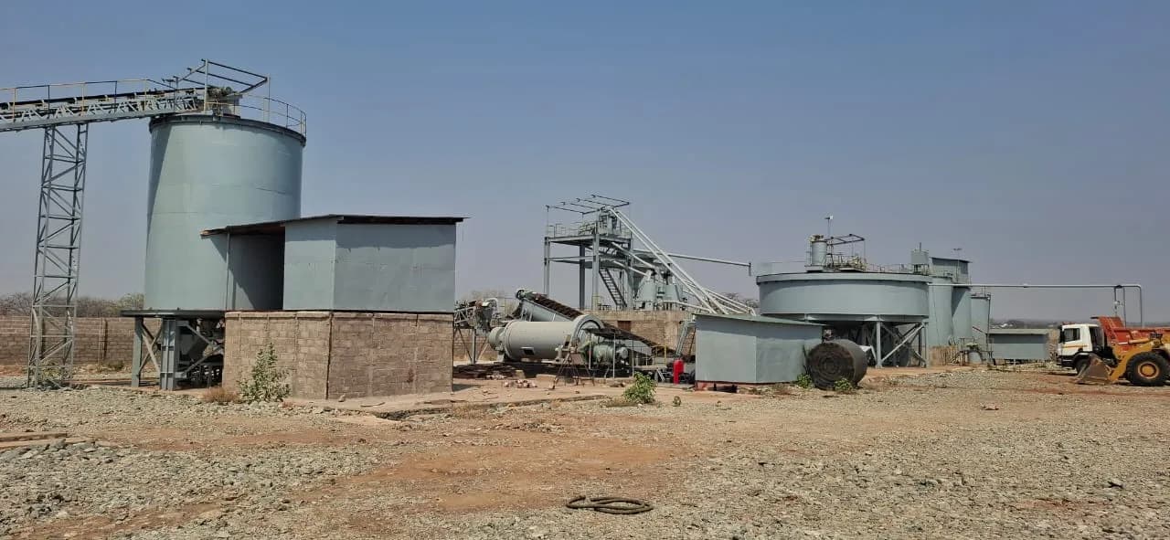 CIP tanks with catwalks and the perimeter wall beyond