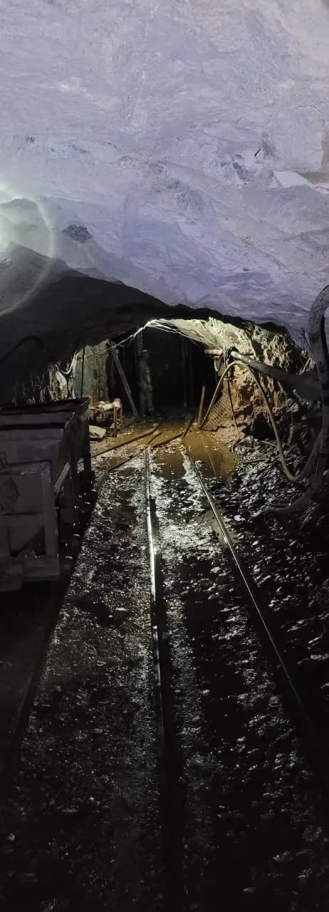 Underground haulage tunnel with an ore cart on rail