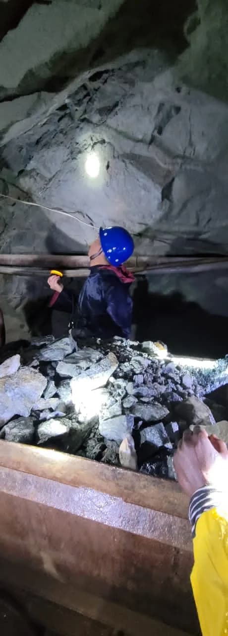 Miner inspecting ore in the underground cart