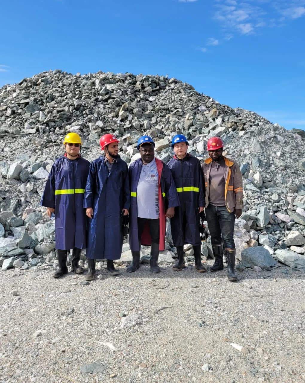 Technical team beside the crushed ore stockpile