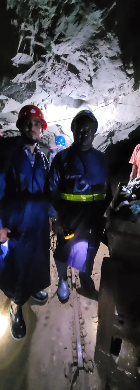 Miners underground with headlamps