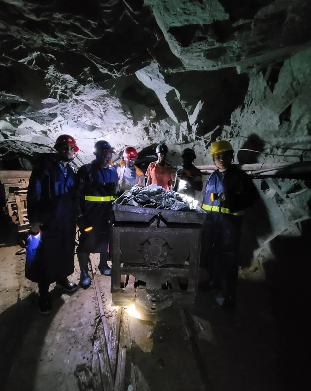 Underground crew with a loaded ore cart