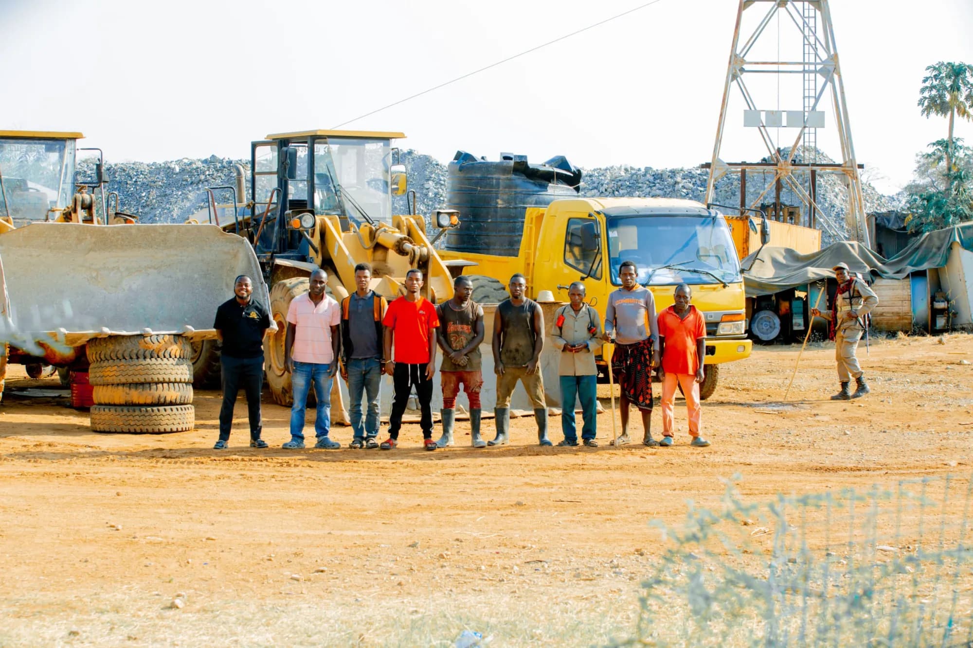 Site team beside the equipment fleet